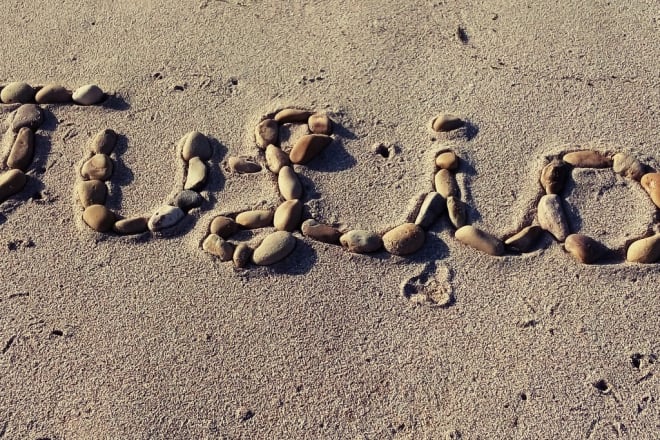 I will write your text on sand with natural shells and beach stones